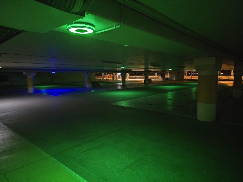 Car park aisle lit by Sensade ceiling parking lamps