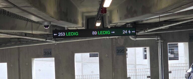 Digital parking signs showing available spaces in a car park
