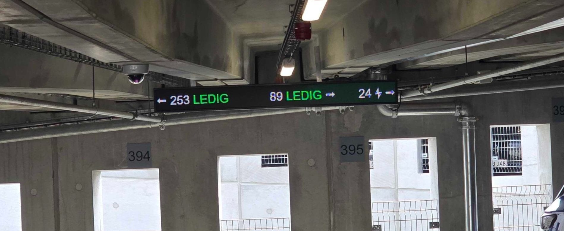 Digital parking signs showing available spaces in a car park